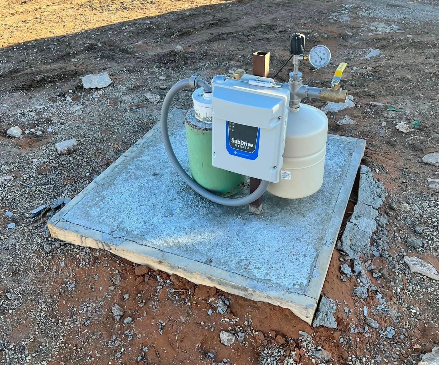 A water pump is sitting on top of a concrete slab in the dirt — Seminole, TX — Shpuetz Drilling A water pump is sitting on top of a concrete slab in the dirt — Seminole, TX — Shpuetz Drilling