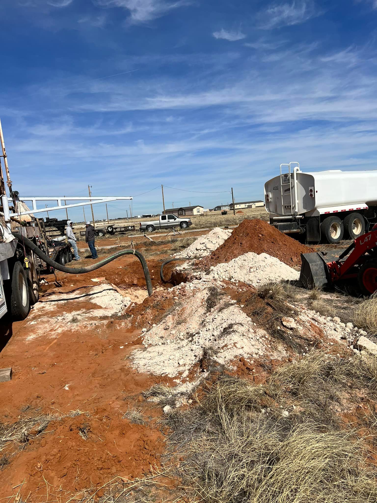A large pile of dirt is sitting in a field next to a truck — Seminole, TX — Shpuetz Drilling