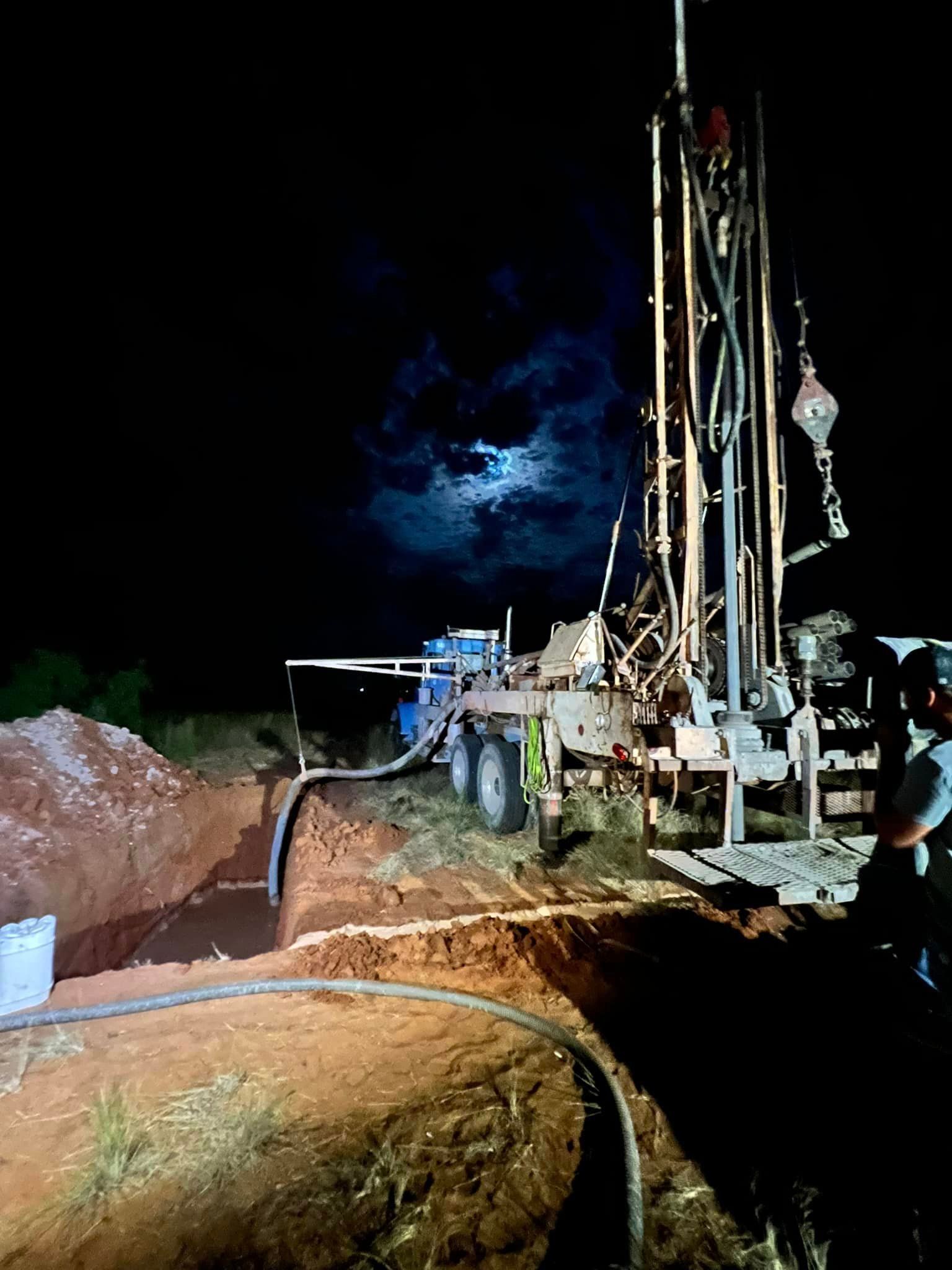 A water well is being drilled at night with a full moon in the background — Seminole, TX — Shpuetz Drilling