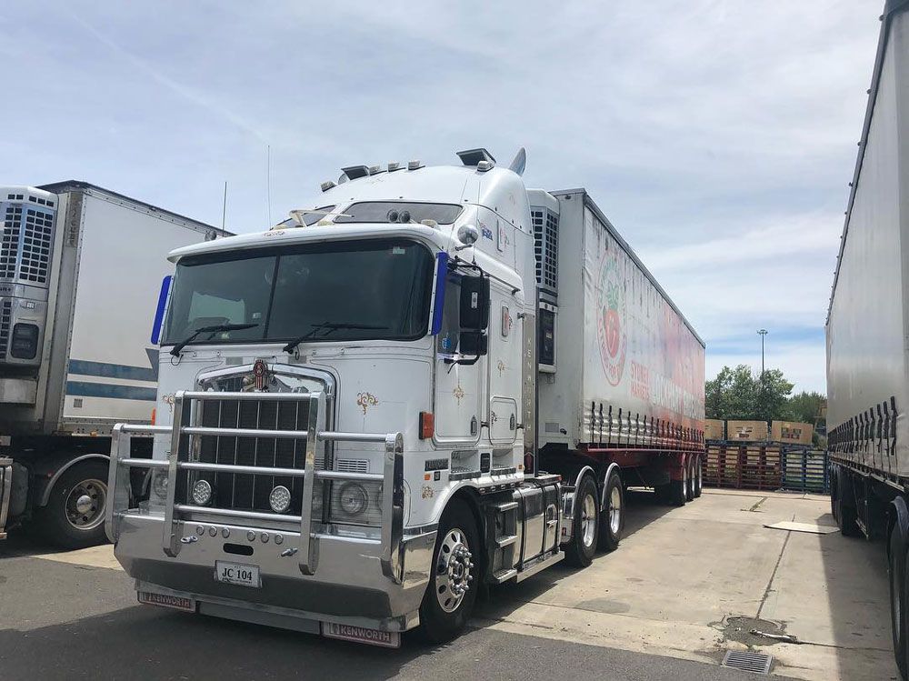 White Truck Parked Near Another Truck — Joe Camilleri Transport in Fyshwick, ACT
