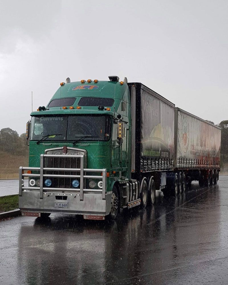 Heavy Truck Travelling on Rainy Road — Joe Camilleri Transport in Fyshwick, ACT