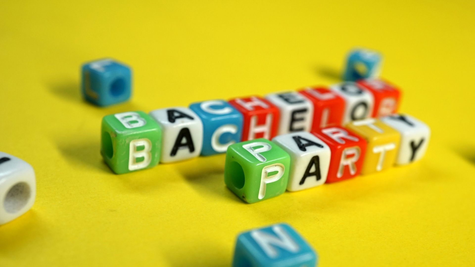 The word bachelor party is written on a yellow background