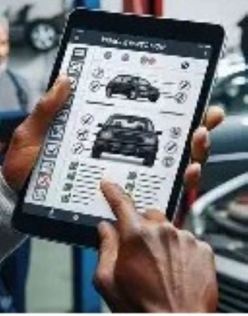 Hands using a tablet to configure a black car on a digital interface.