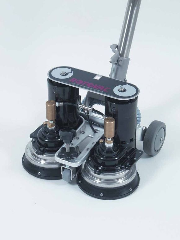 A vacuum cleaner is sitting on a white surface.