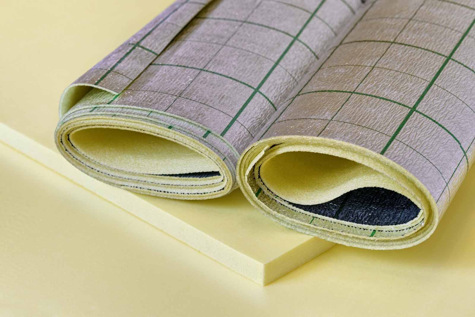 Two rolls of fabric are rolled up on a table.