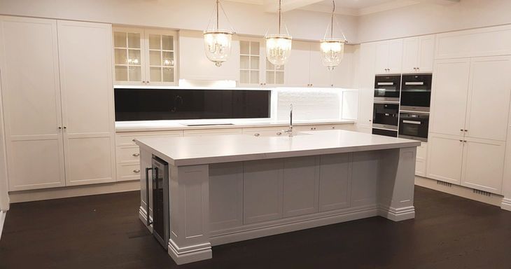 There is a large island in the middle of the kitchen.