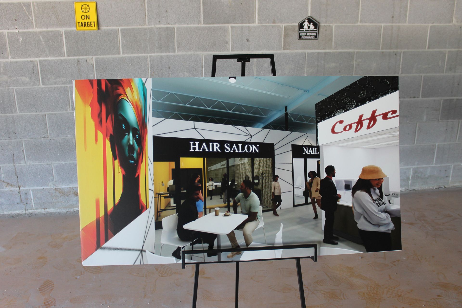 A board on an easel displays an architectural rendering of an indoor mall with a hair salon and a coffee shop.