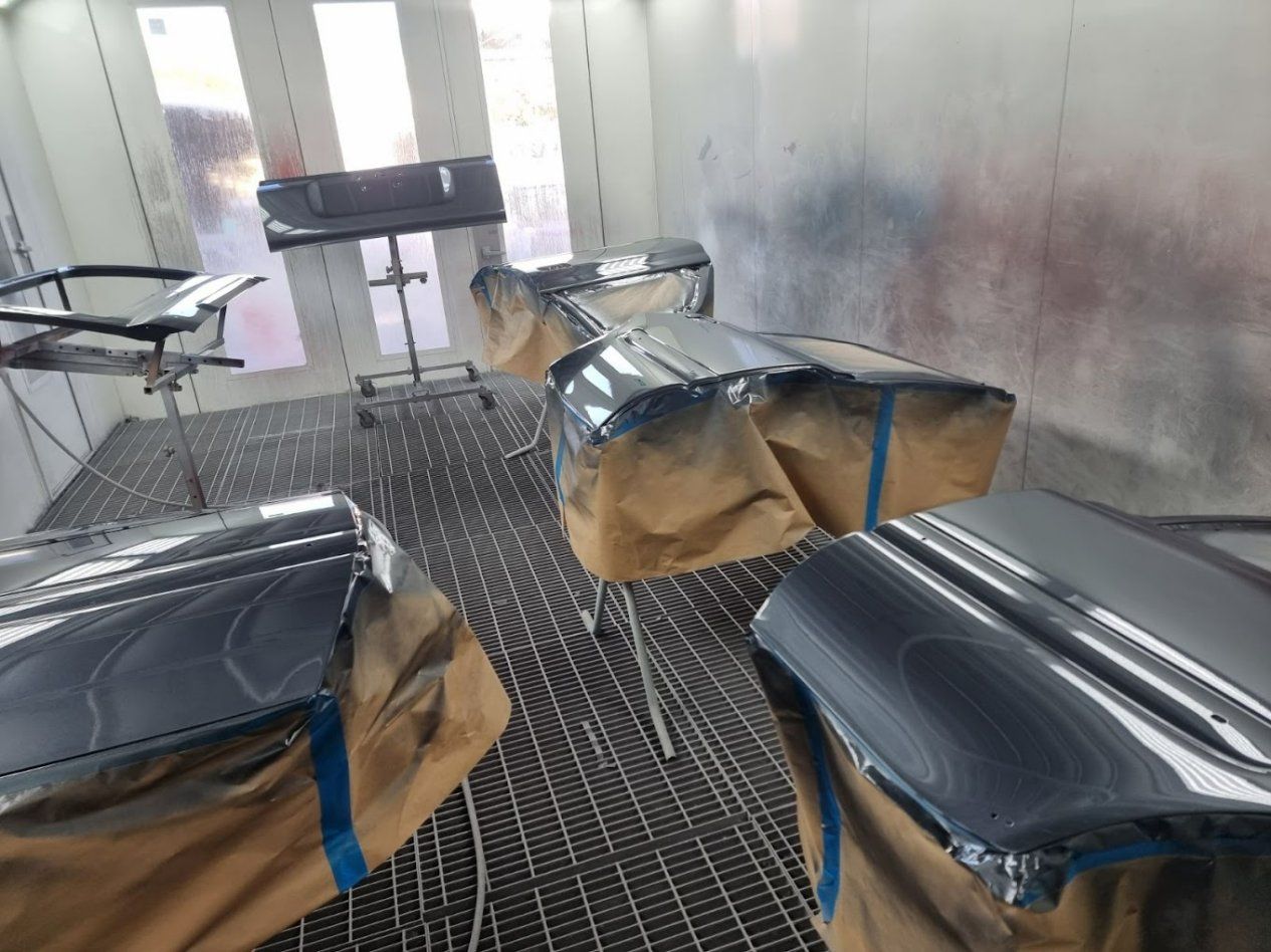 A Car Is Being Painted in A Paint Booth — East Maitland Body Repairs in East Maitland, NSW