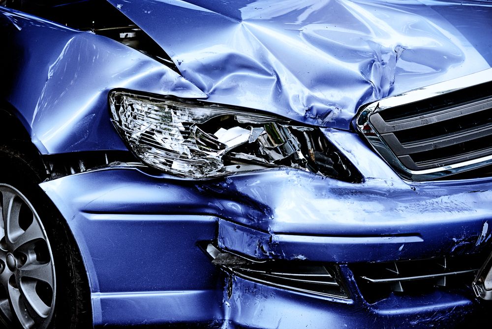 A blue car has been damaged in a car accident. — East Maitland Body Repairs in East Maitland, NSW