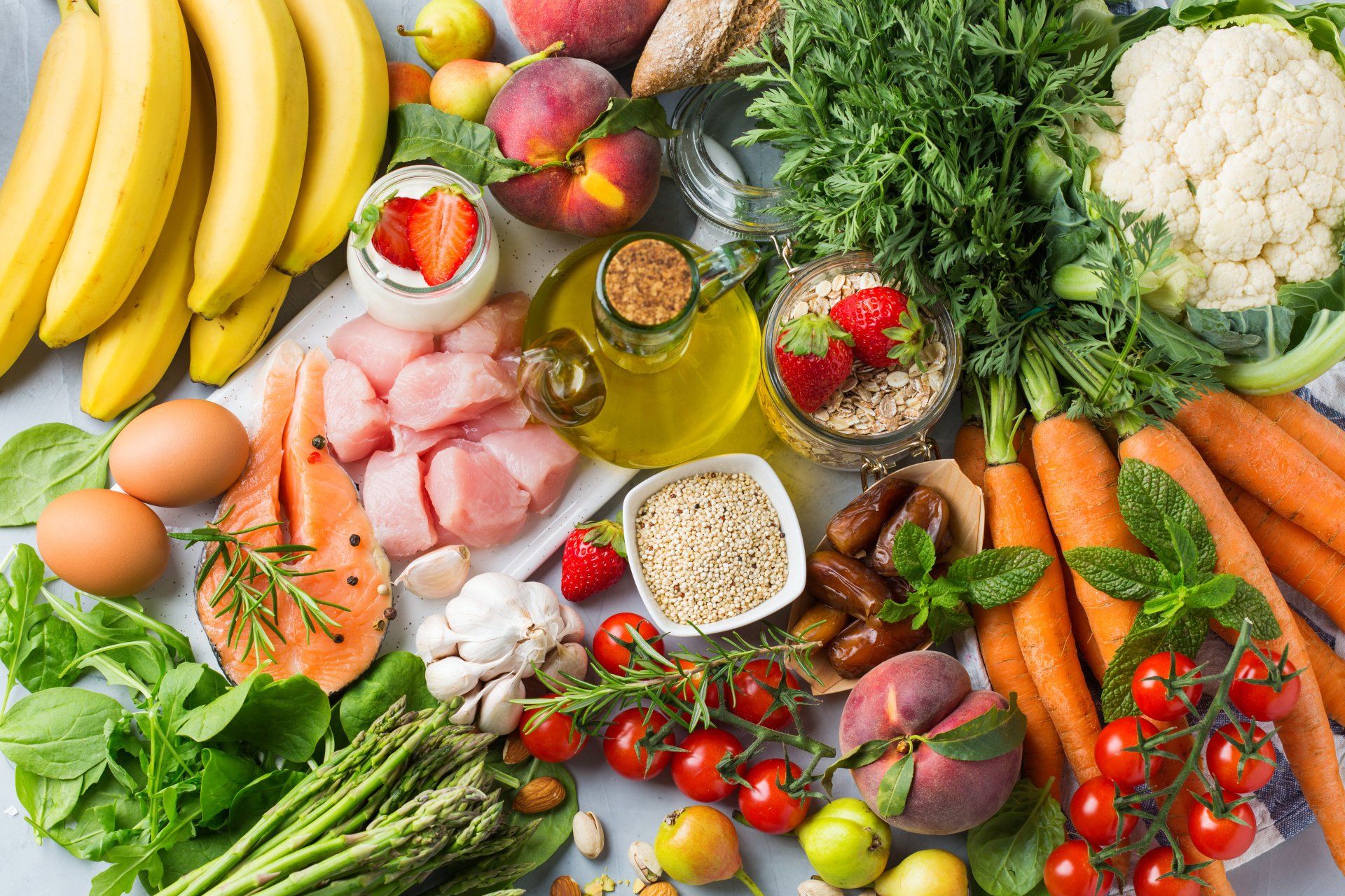 There are many different types of fruits and vegetables on the table.