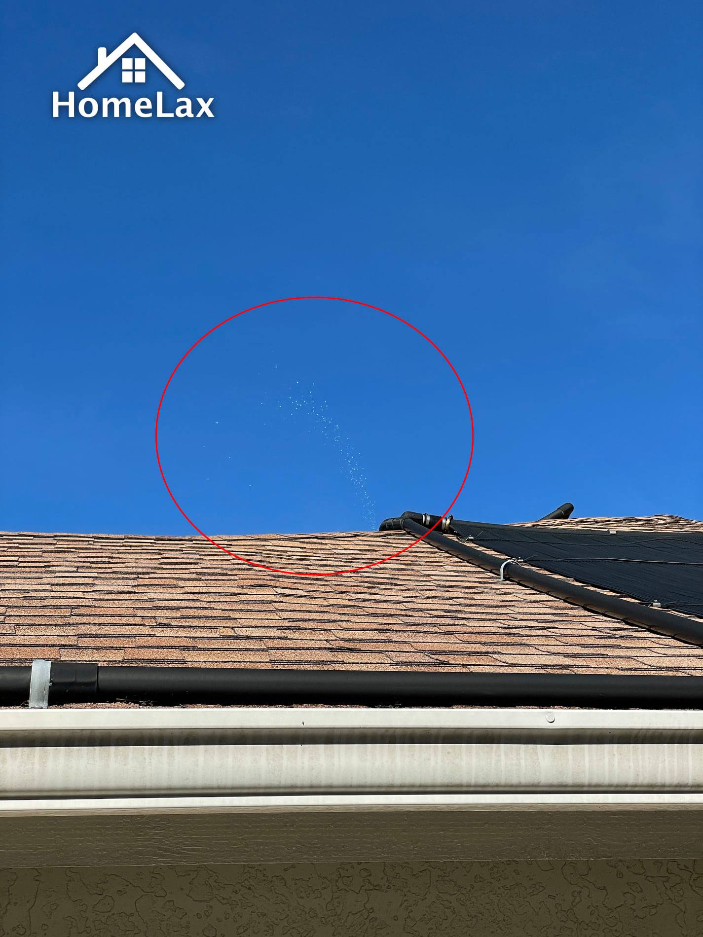 A house roof against a blue sky, with a red circle highlighting a line of small light spots visible above the roof ridge.
