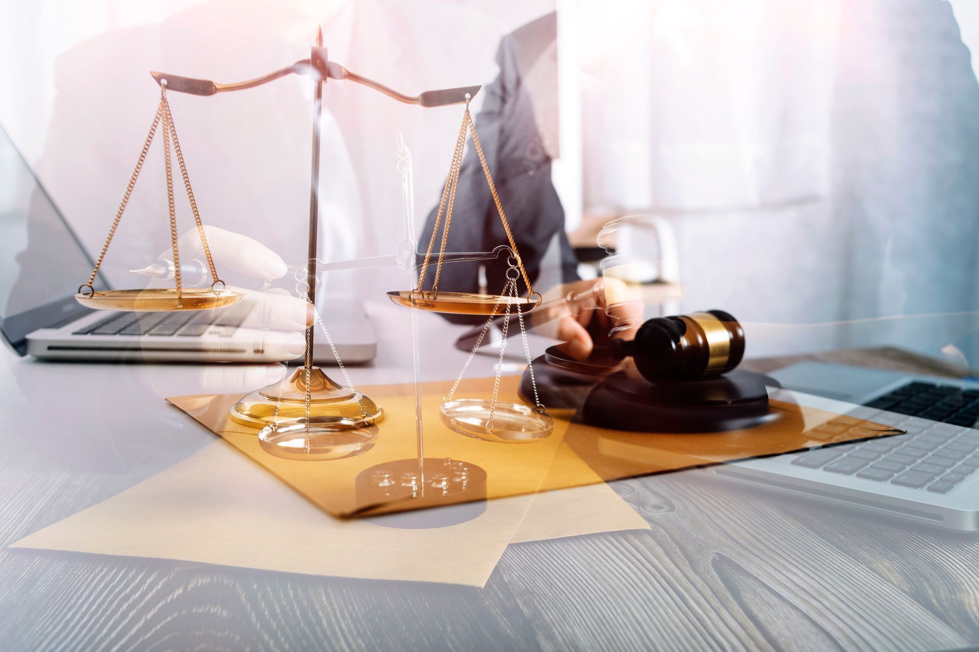 Lawyer’s desk with scales of justice, gavel, and books in a bright office