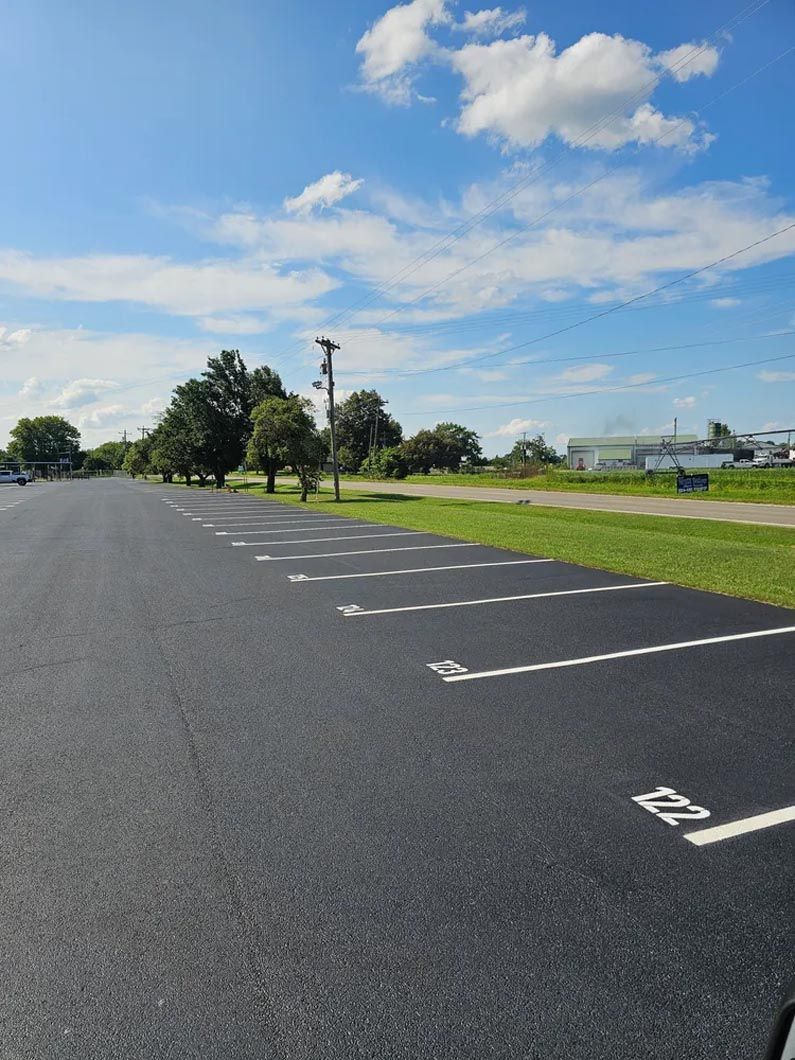 A parking lot with a handicapped sign on the side of the road.