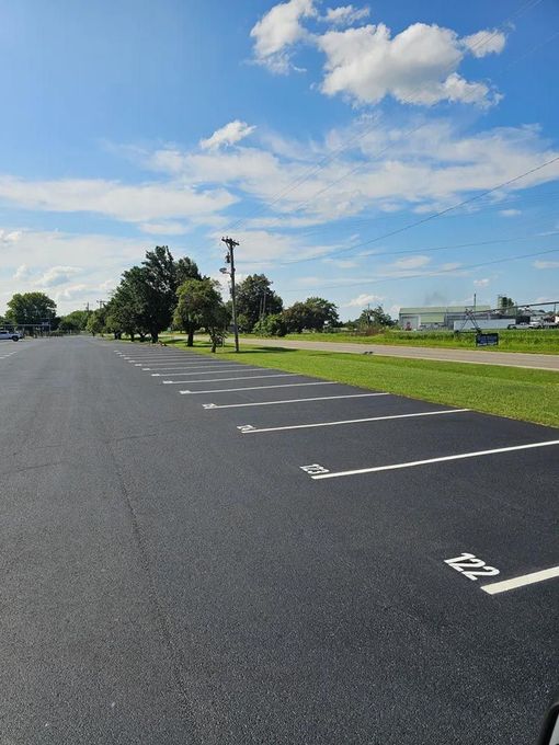 A parking lot with a handicapped sign on the side of the road.