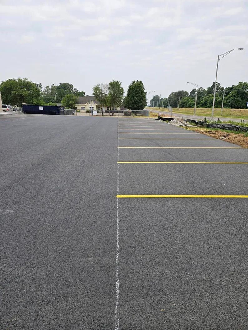 A parking lot with yellow lines on the side of it.