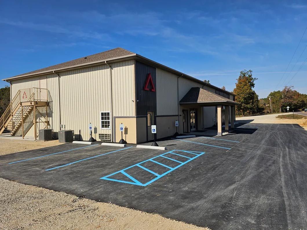 A large building with a parking lot in front of it.