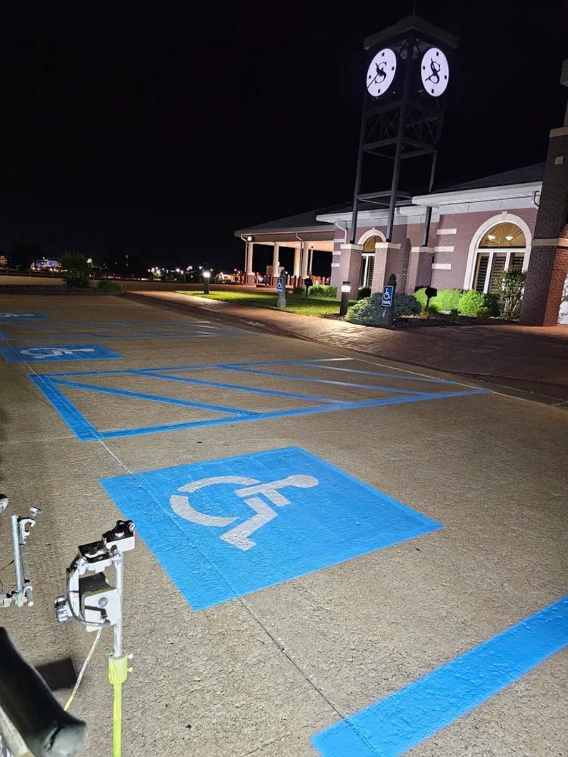 A handicapped parking spot in front of a clock tower