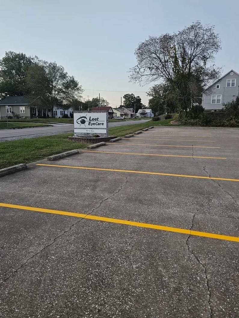 A parking lot with a sign in the middle of it.