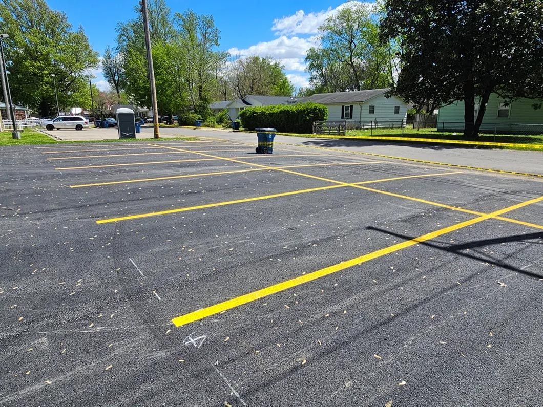 A parking lot with yellow lines painted on it.