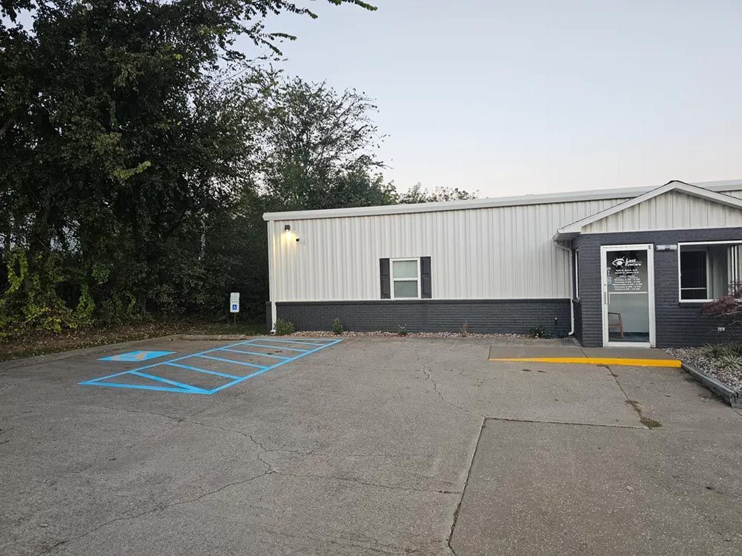 A mobile home with a handicapped parking spot in front of it.