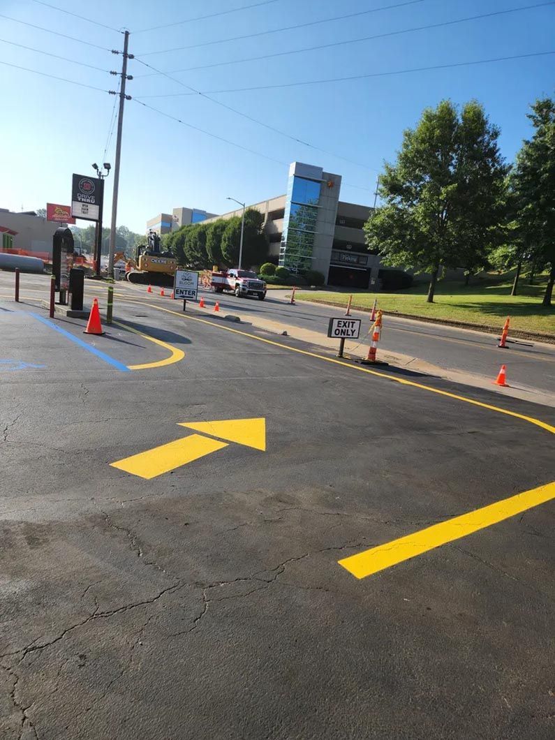 A yellow arrow is painted on the side of the road