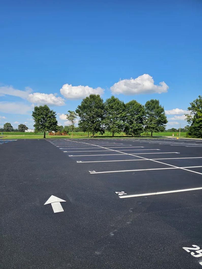 A parking lot with a white arrow pointing to the right
