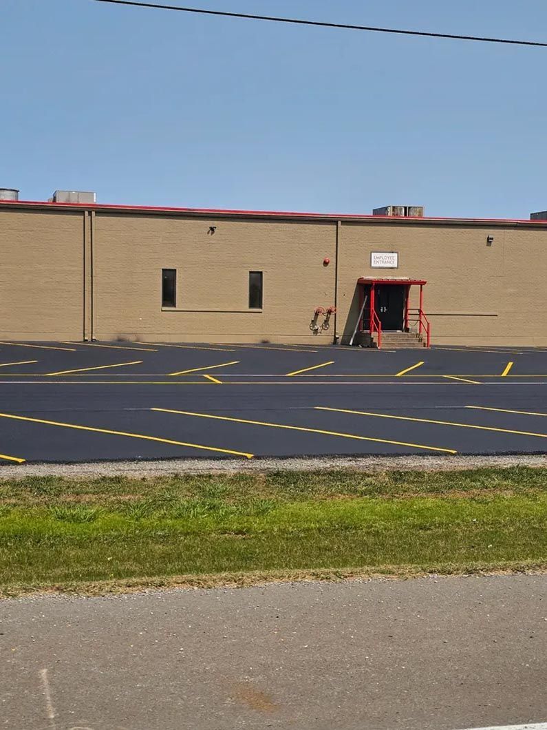 A large brick building with a parking lot in front of it