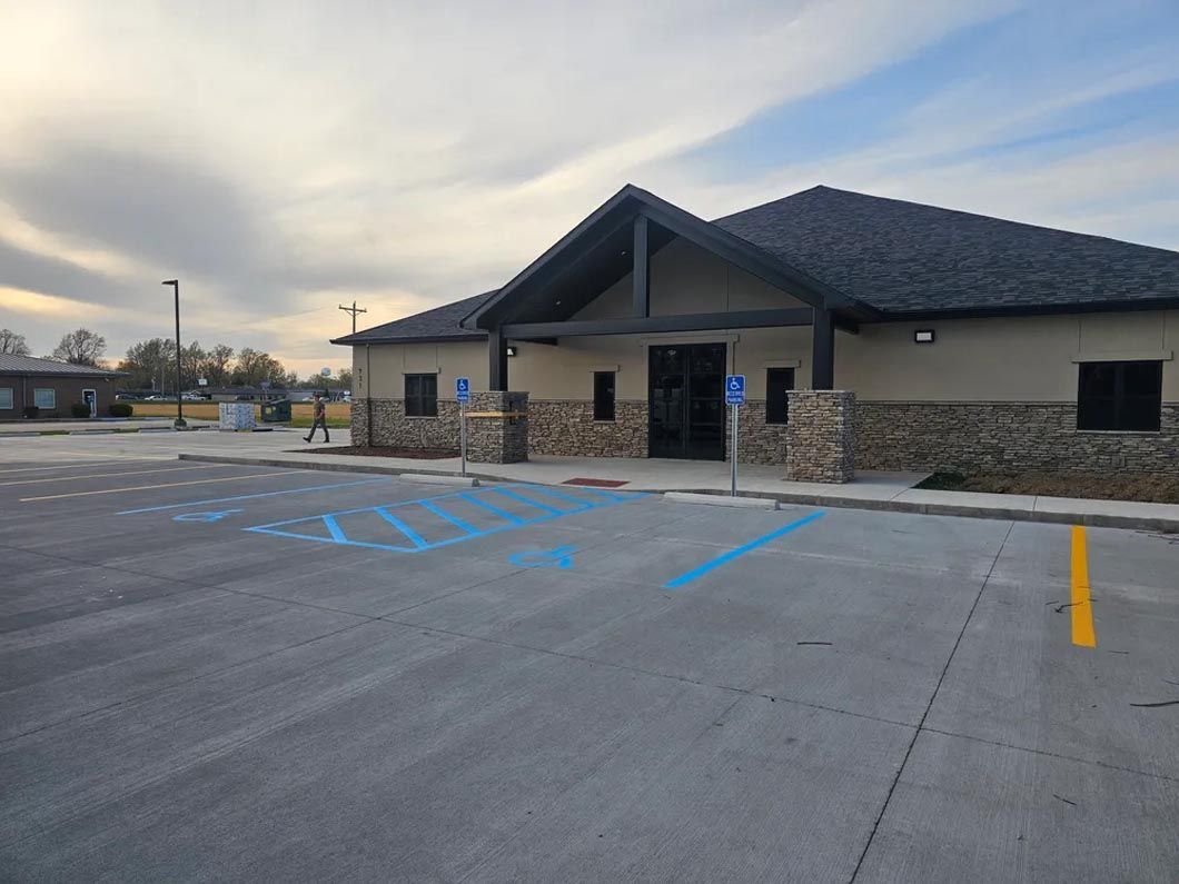 A large building with a handicapped parking spot in front of it.