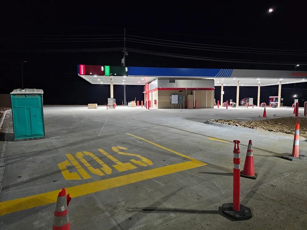 A gas station with a stop sign painted on the side of the road.