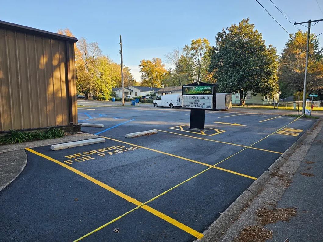 A parking lot with a sign in the middle of it.