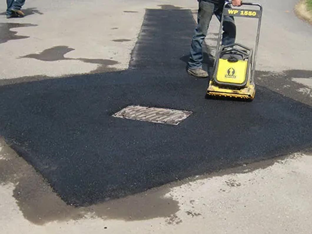 A man is using a machine that has the letter o on it