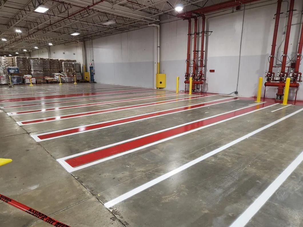 A large warehouse with red and white lines on the floor.