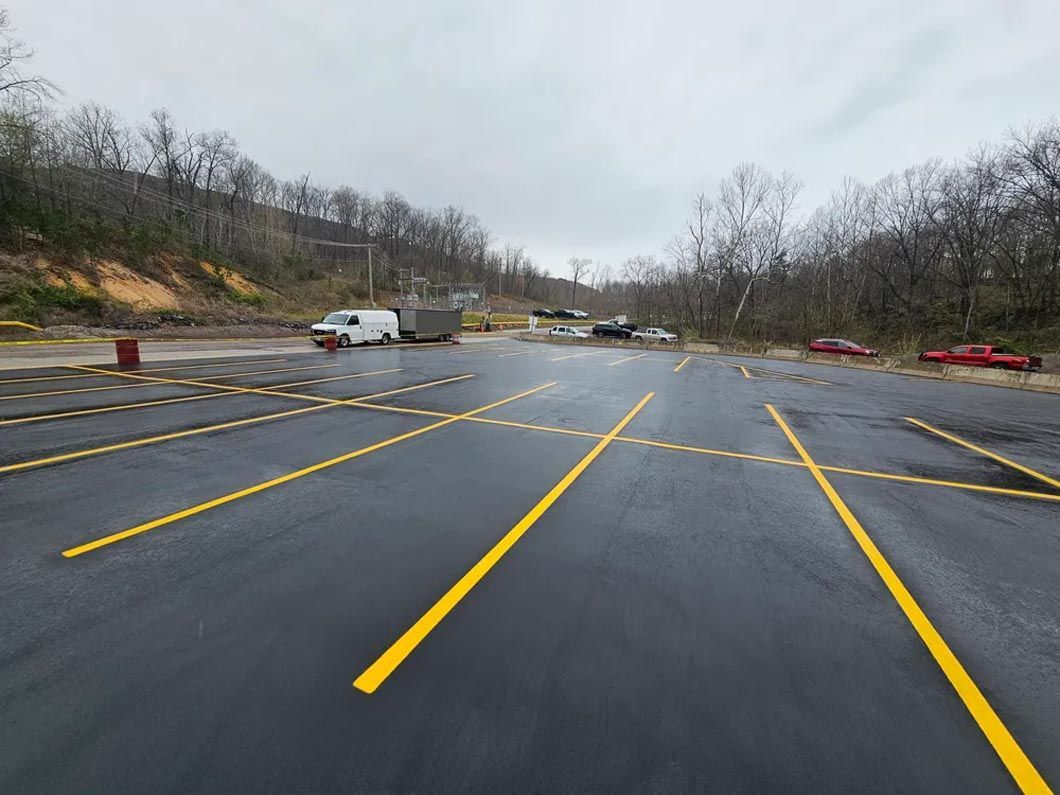 A parking lot with yellow lines on the side of the road