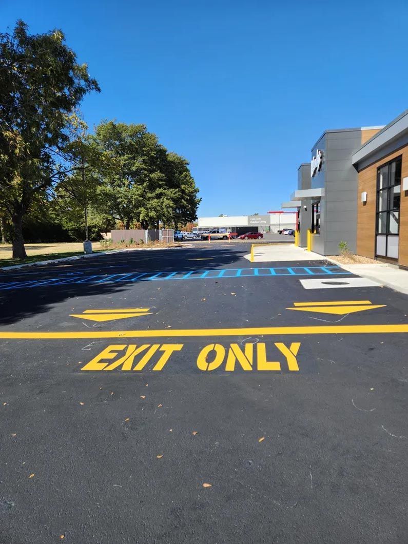 A parking lot with a yellow line that says exit only