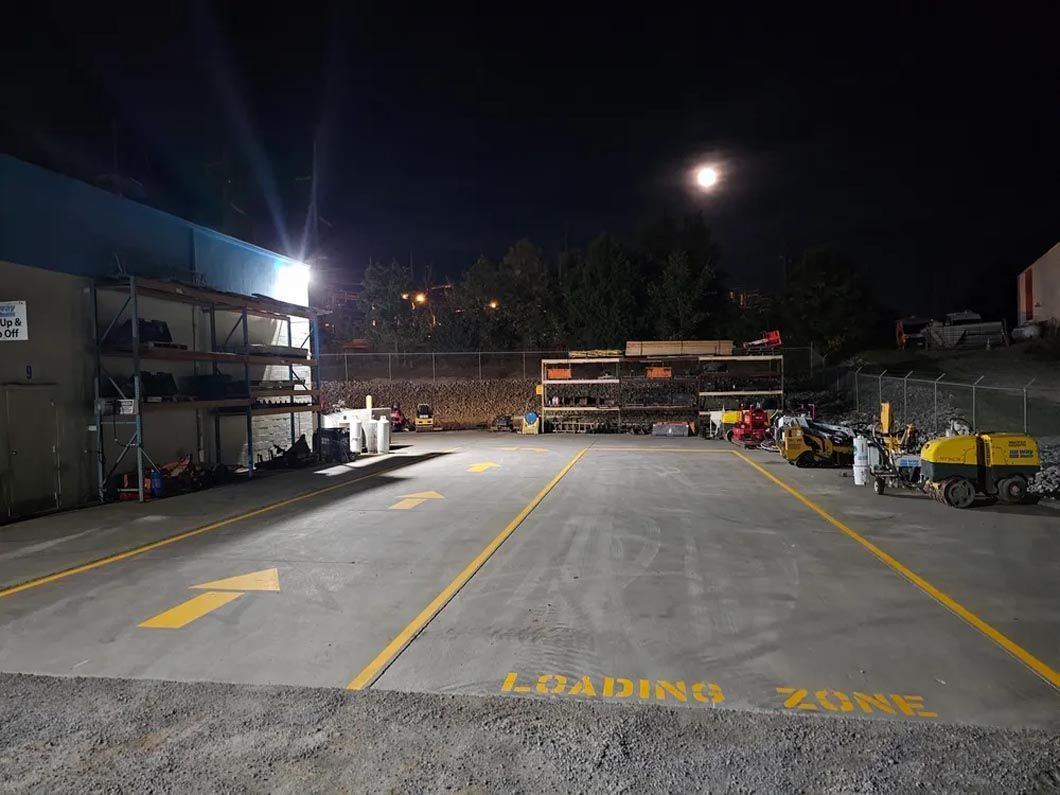 A parking lot with a lot of trucks parked in it at night.