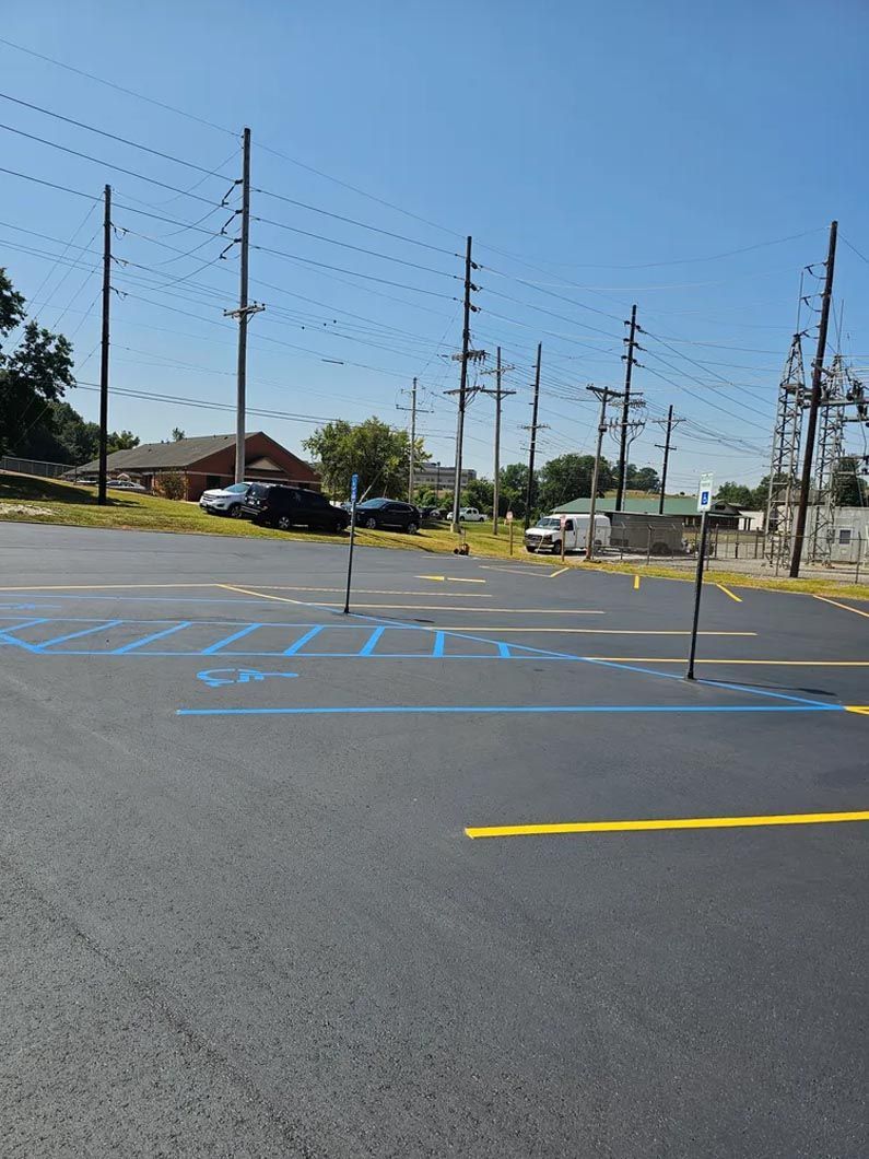 A parking lot with a lot of power lines in the background