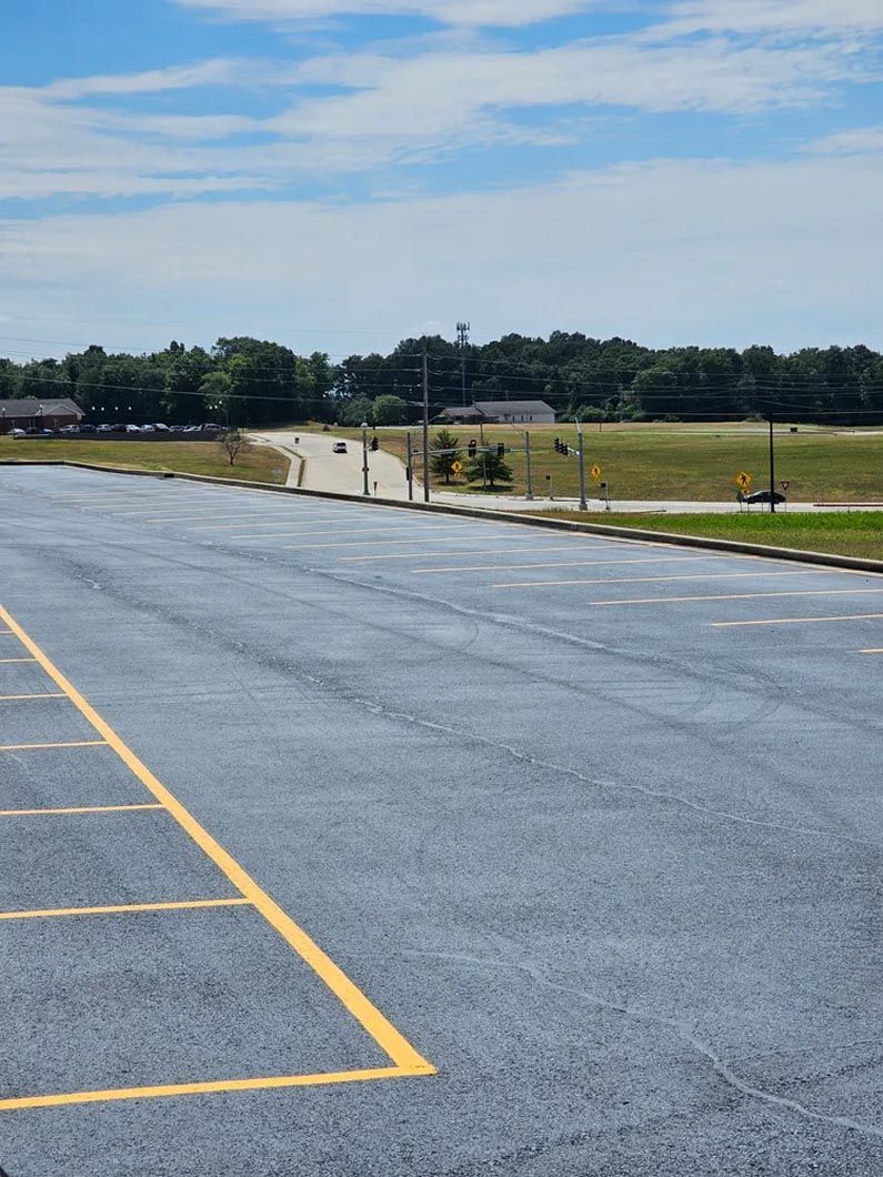 An empty parking lot with a yellow line in the middle