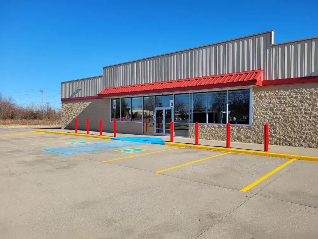 A large building with a handicapped parking spot in front of it.