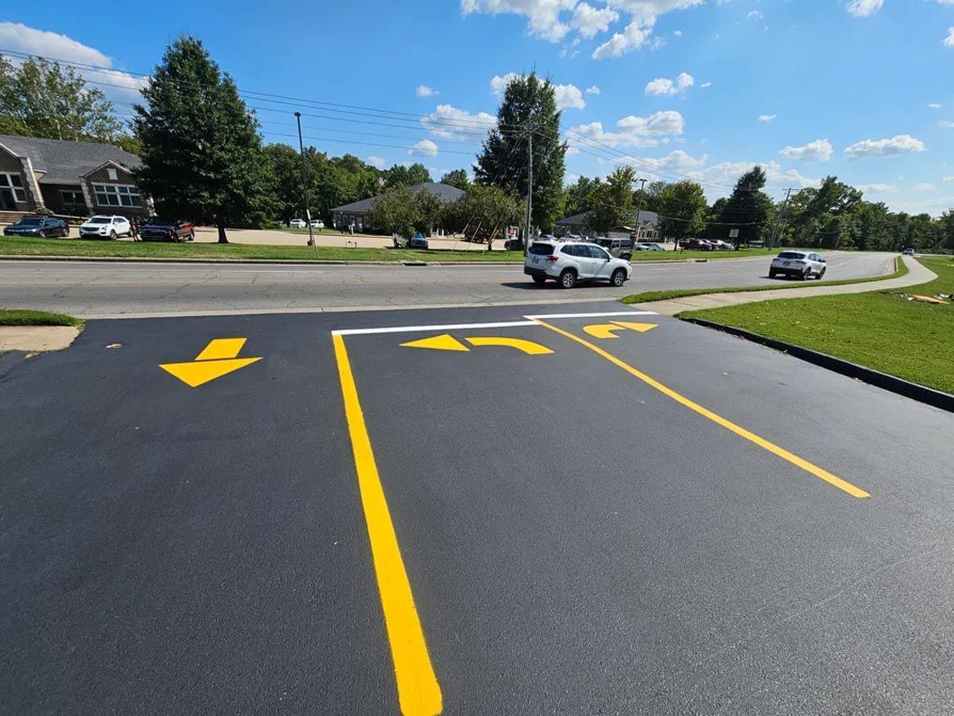 A parking lot with arrows painted on the side of it