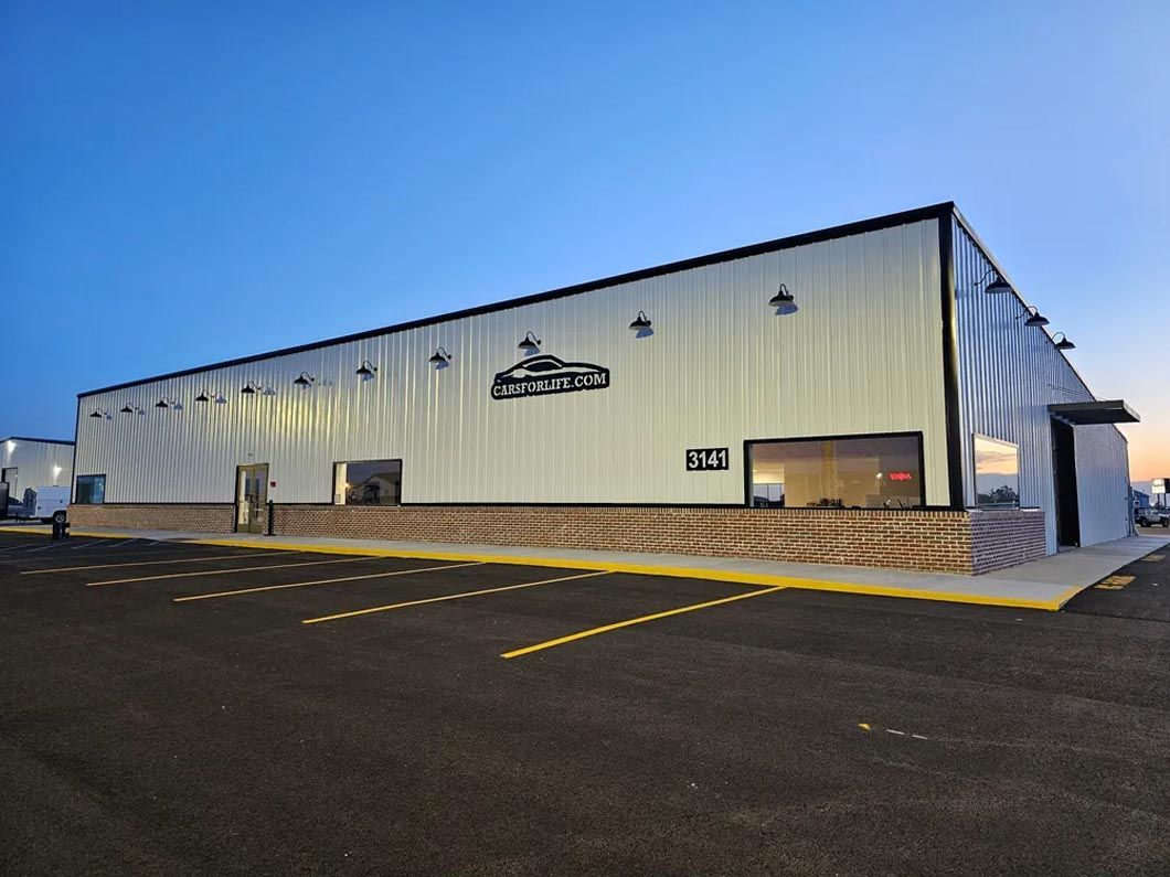 A large white building with a logo on the side of it
