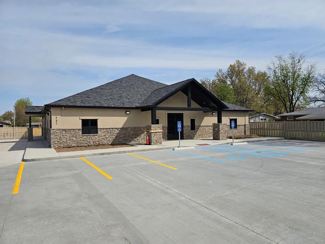 A large building with a parking lot in front of it.
