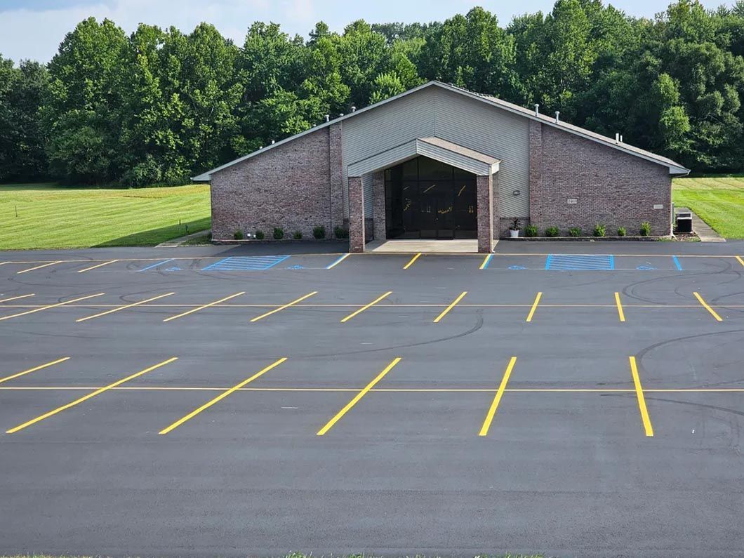 A large building with a parking lot in front of it.