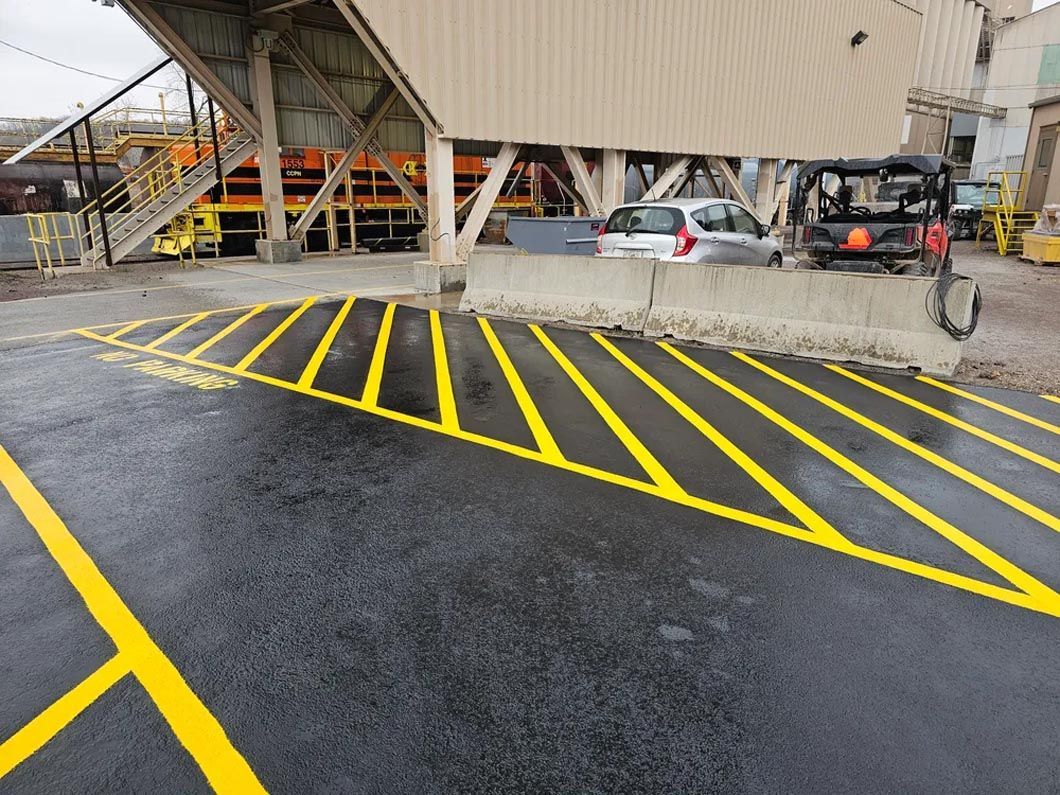 A parking lot with yellow lines on it in front of a building