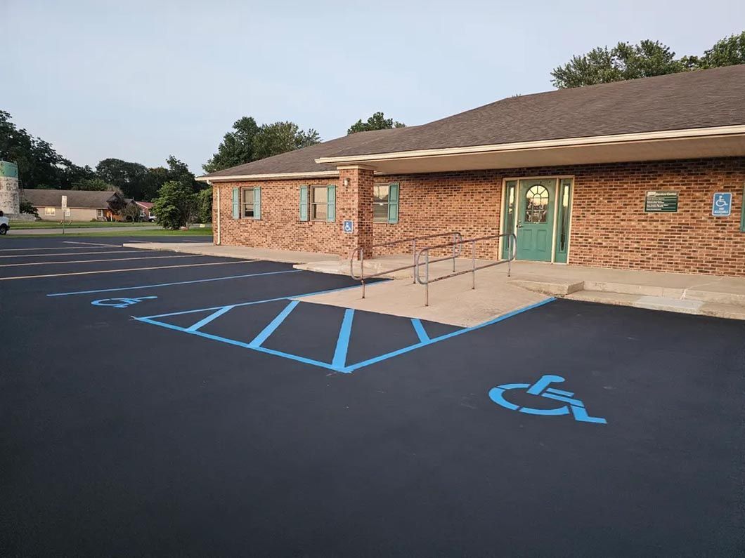 A handicapped parking spot in front of a brick building