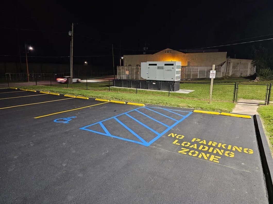 A parking lot with a handicapped parking spot and a no parking loading zone.