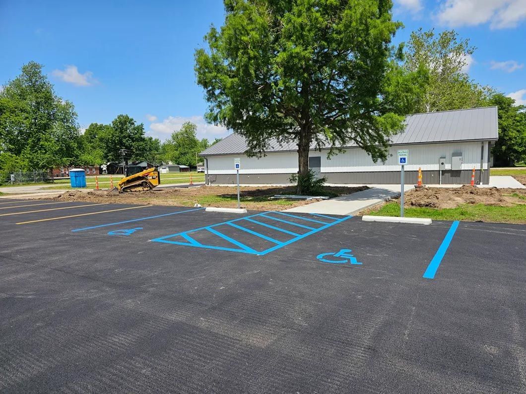A handicapped parking spot is painted blue in a parking lot.
