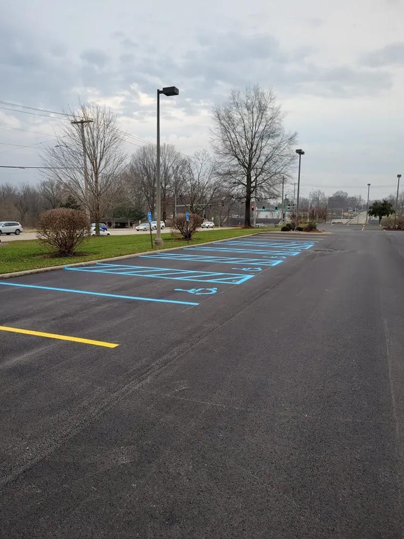 A parking lot with a handicapped parking spot painted blue.