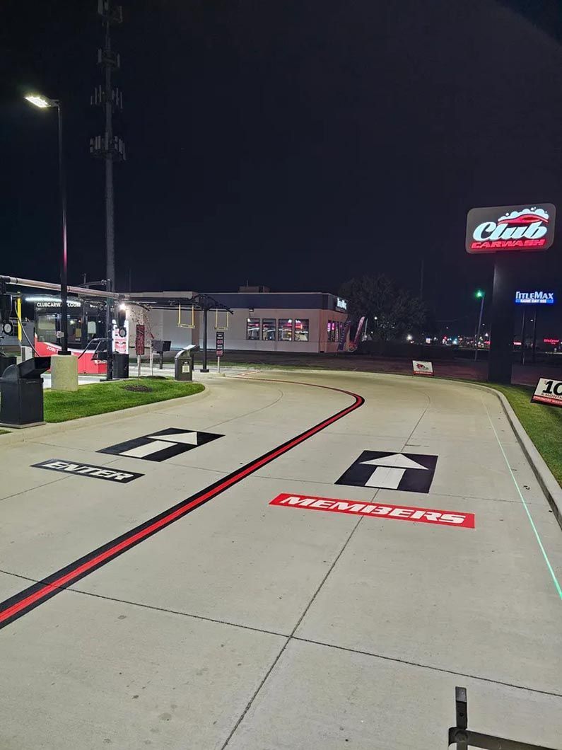 A race track at night with a sign that says clark on it