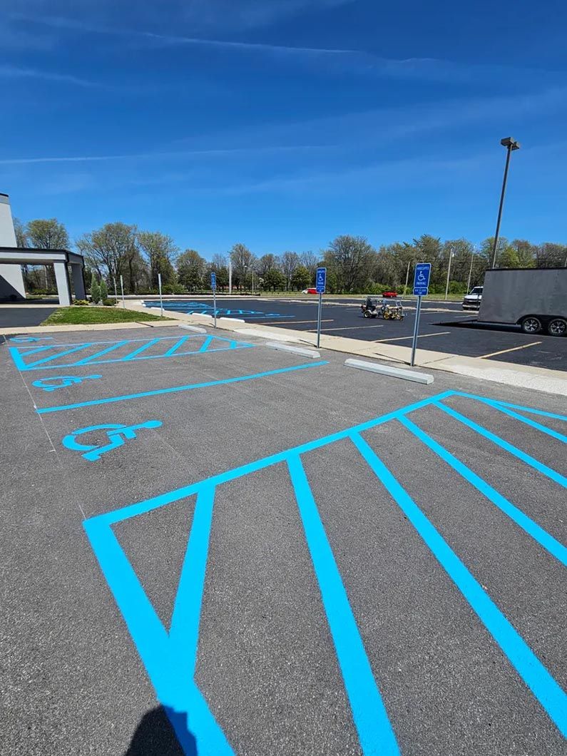 A handicapped parking spot is painted blue in a parking lot