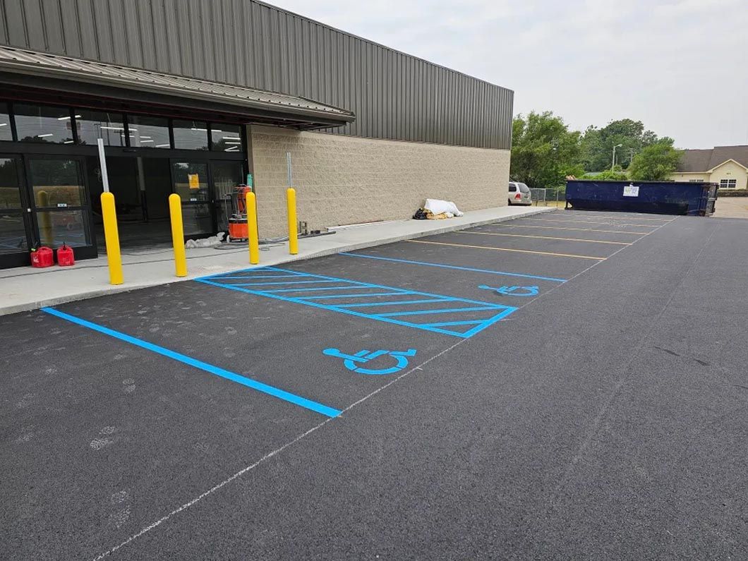 A handicapped parking spot is painted blue in front of a building.